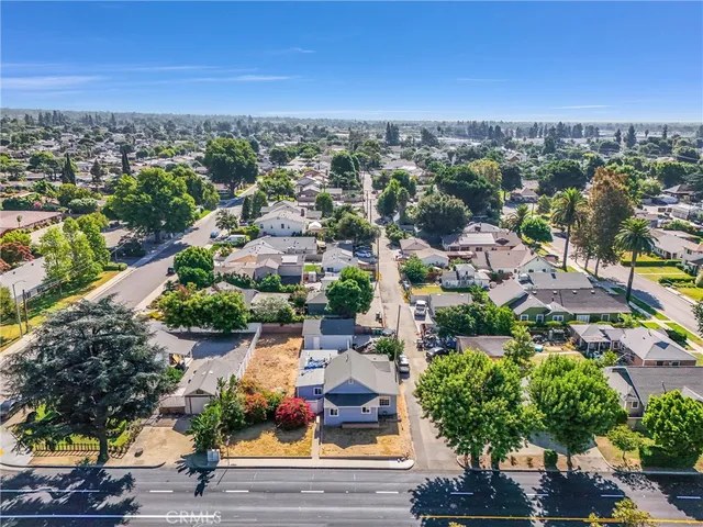 an aerial view of residential houses with outdoor space and ocean view