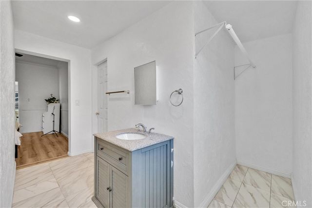 a spacious bathroom with a sink and a mirror