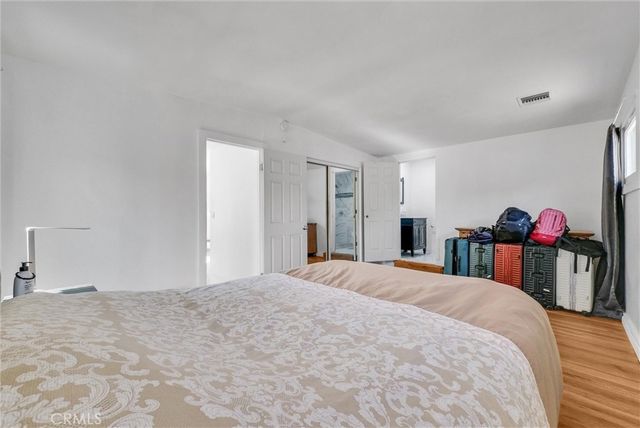 a bedroom with a bed and a closet