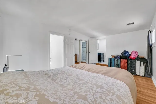 a bedroom with a bed and a closet