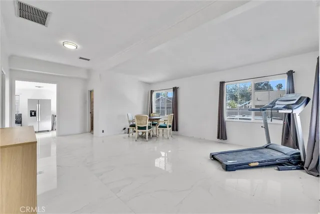 a view of a livingroom with furniture and a floor to ceiling window