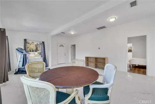 a bedroom with furniture and a mirror