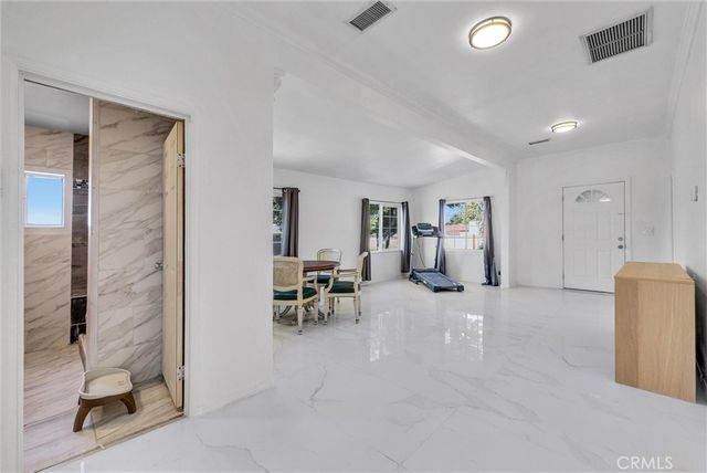 a view of a livingroom with furniture and a bathroom