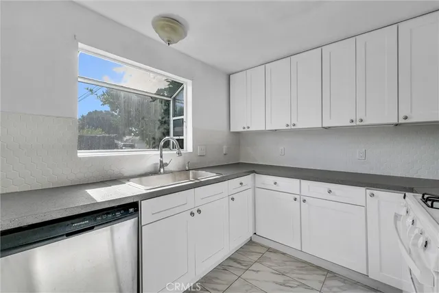 a kitchen with a sink and cabinets