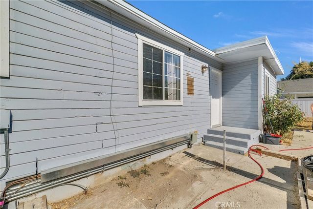a view of a patio with a table and chairs and potted plants