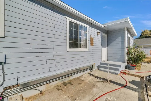a view of a patio with a table and chairs and potted plants