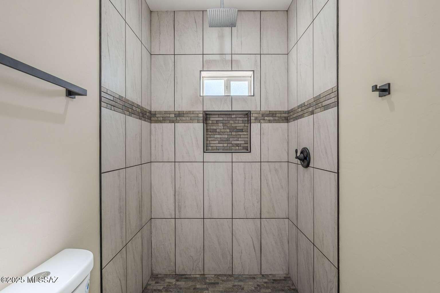1796 Cajeme Court Rio Rico, AZ 85648 - Photo 20 of 45 a bathroom with a shower and toilet