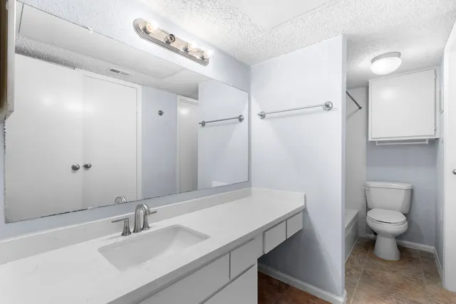 a bathroom with a toilet a sink and bathtub