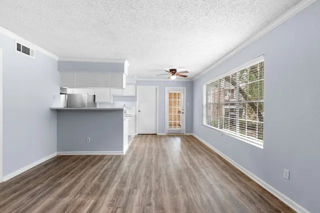 a view of a room with wooden floor and window