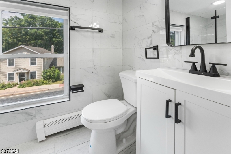 113 Rt560 Layton, NJ 07851 - Photo 10 of 17 a bathroom with a sink a toilet and a mirror