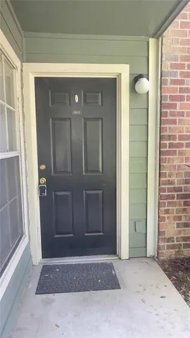 a view of a kitchen with a sink and a refrigerator