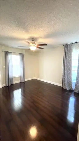 a bathroom with a granite countertop sink toilet a mirror a vanity and shower