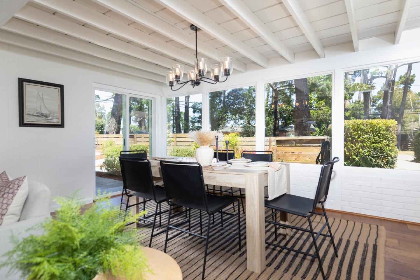 4138 Crest Road Pebble Beach, CA 93953 - Photo 12 of 38 a view of a dining room with furniture large windows and wooden floor