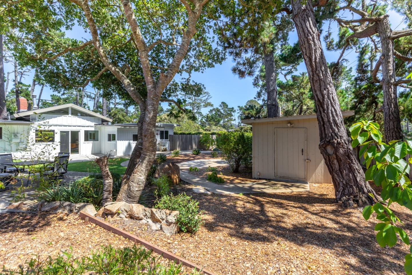 4138 Crest Road Pebble Beach, CA 93953 - Photo 33 of 38 a front view of a house with a yard and trees