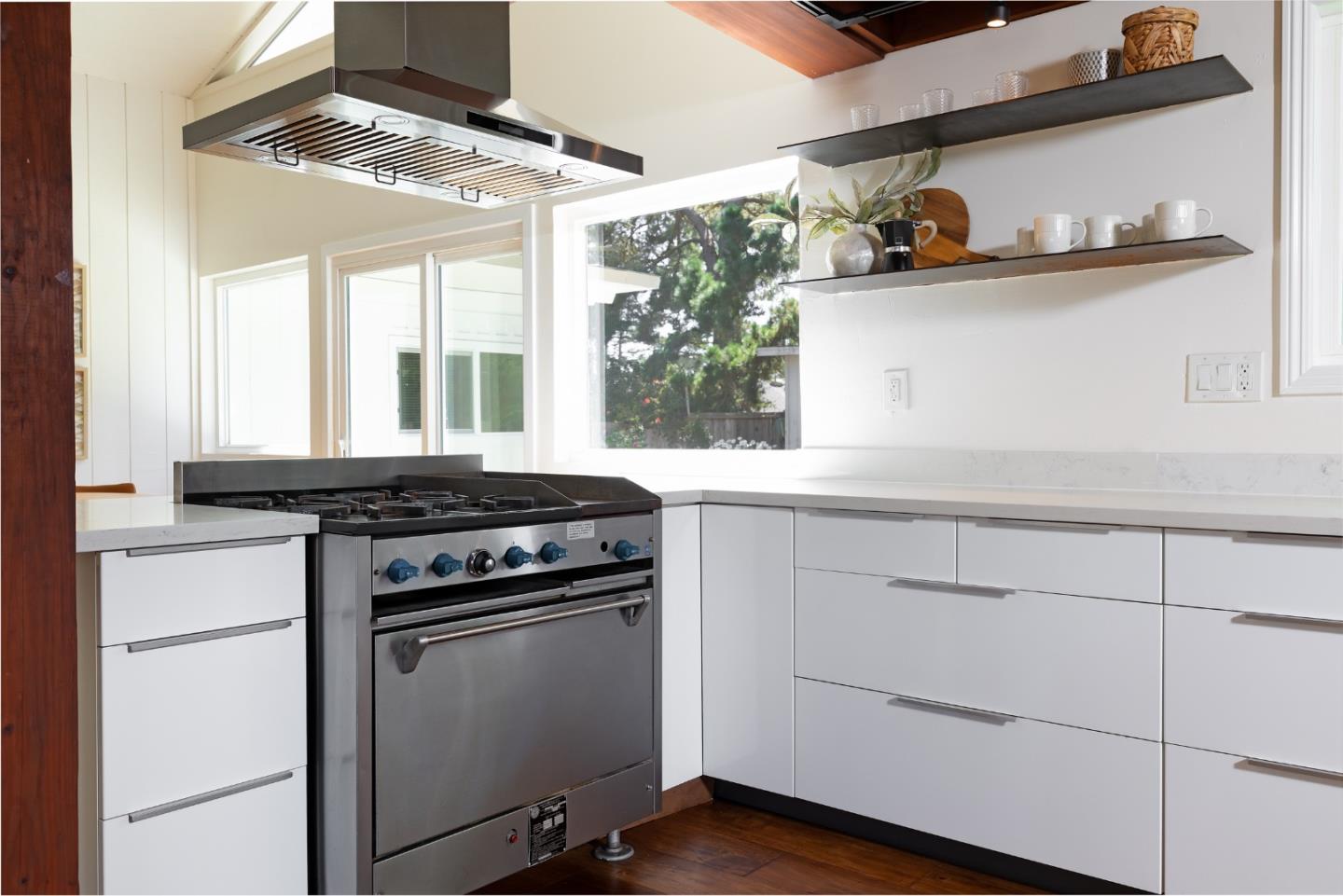 4138 Crest Road Pebble Beach, CA 93953 - Photo 9 of 38 a kitchen with white cabinets and appliances