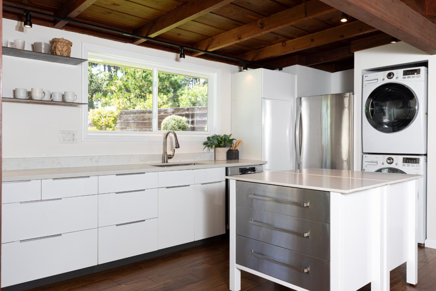4138 Crest Road Pebble Beach, CA 93953 - Photo 10 of 38 a kitchen with stainless steel appliances granite countertop a sink a window and wooden floors