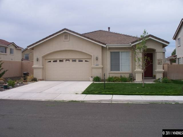 10065 Silver Star Drive Reno, NV 89521 - Photo 1 of 13 a front view of a house with a yard and garage