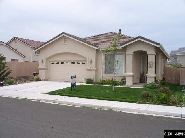 10065 Silver Star Drive Reno, NV 89521 - Photo 13 of 13 a front view of a house with a yard and garage