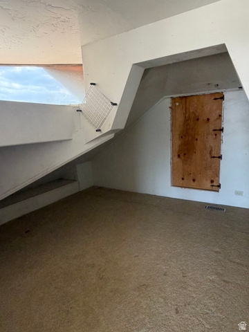 255 E Centre Spring City, UT 84662 - Photo 24 of 34 Carpeted room featuring a unique architectural ceiling design and a horizontal window