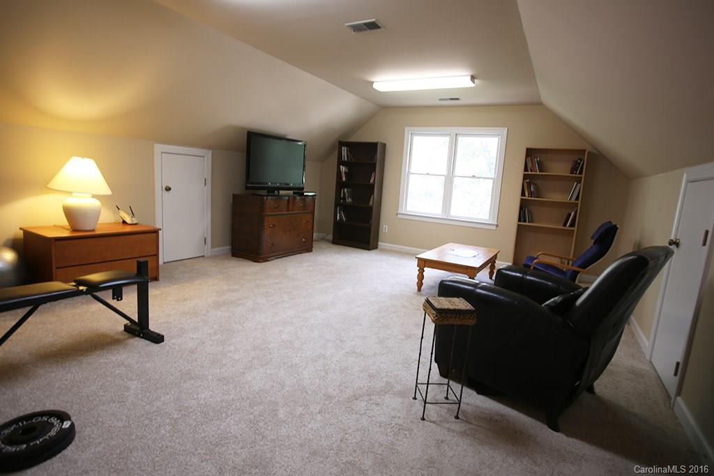 7226 Colony Road Charlotte, NC 28226 - Photo 11 of 24 a living room with furniture a flat screen tv and a window