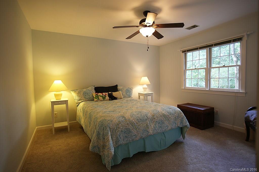 7226 Colony Road Charlotte, NC 28226 - Photo 12 of 24 a bedroom with a bed and a chandelier