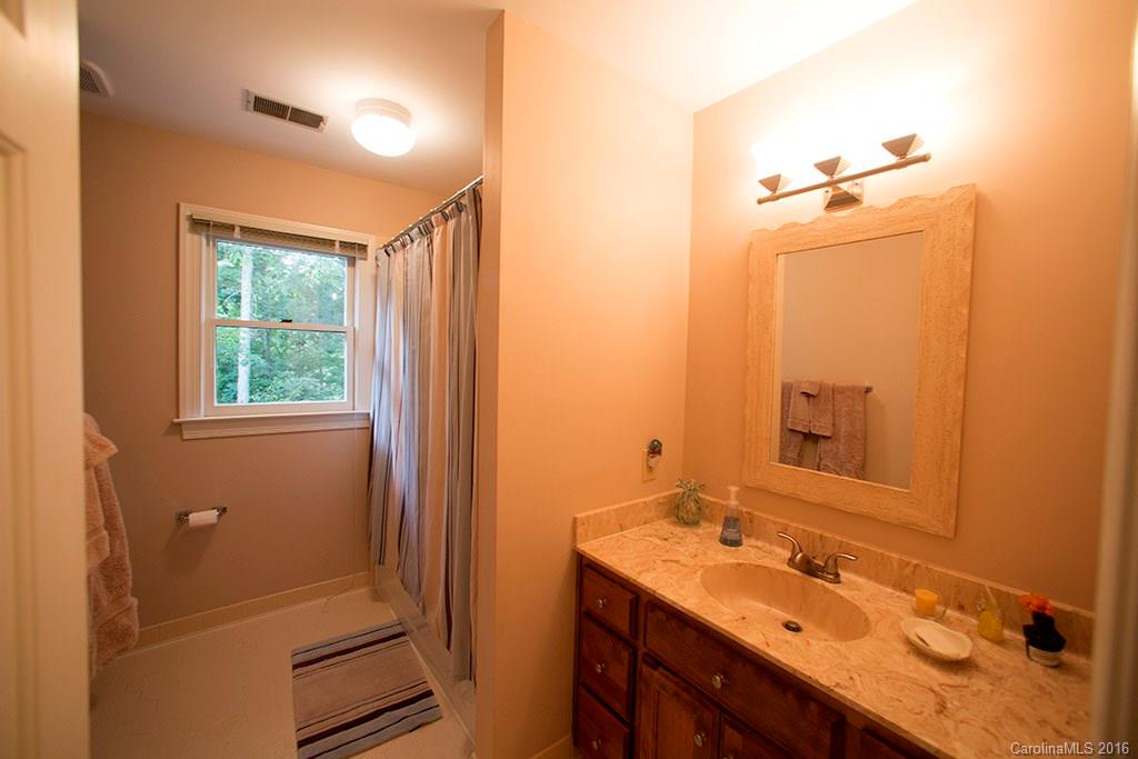 7226 Colony Road Charlotte, NC 28226 - Photo 14 of 24 a bathroom with a sink a mirror and a shower