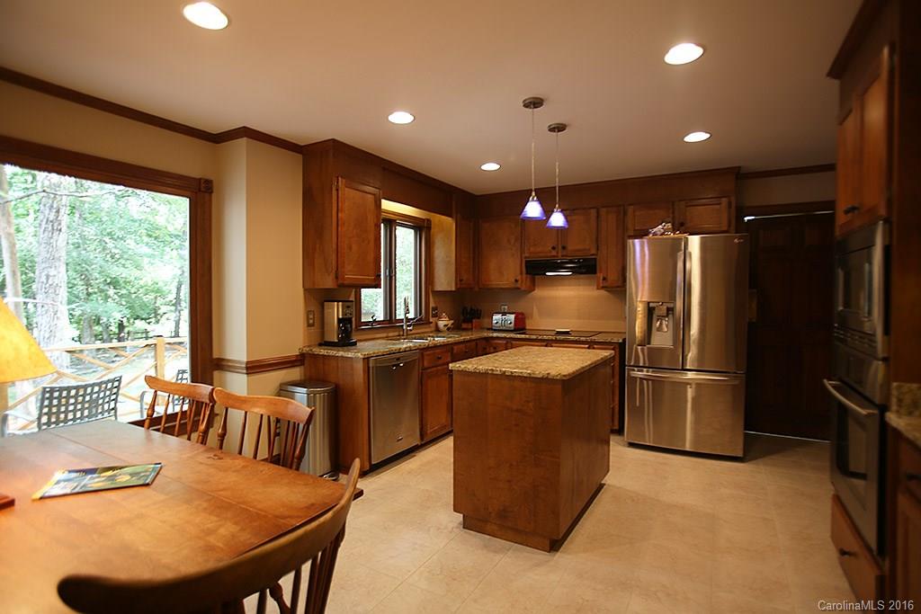 7226 Colony Road Charlotte, NC 28226 - Photo 4 of 24 a kitchen with sink refrigerator dining table and chairs