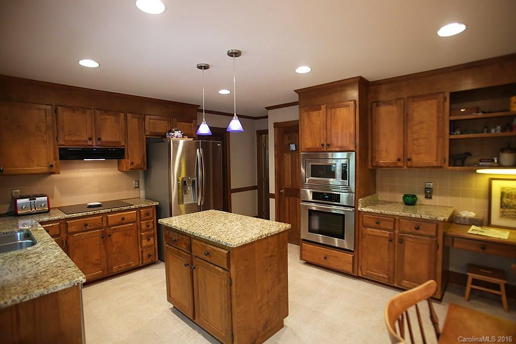 7226 Colony Road Charlotte, NC 28226 - Photo 5 of 24 a kitchen with kitchen island stainless steel appliances a sink stove and refrigerator