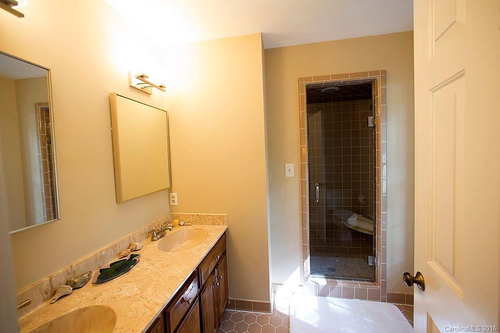 7226 Colony Road Charlotte, NC 28226 - Photo 10 of 24 a bathroom with a sink a toilet and shower
