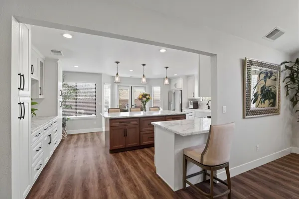 a kitchen with stainless steel appliances granite countertop a stove and a refrigerator