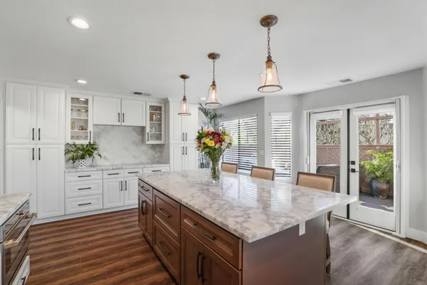 a kitchen with stainless steel appliances granite countertop a sink and a refrigerator