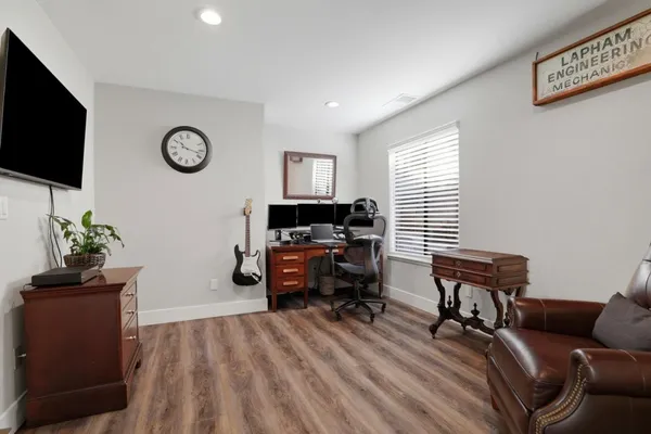 a bedroom with a bed and a large mirror