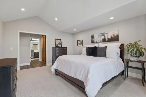 a spacious bathroom with a granite countertop sink a toilet a mirror and bathtub