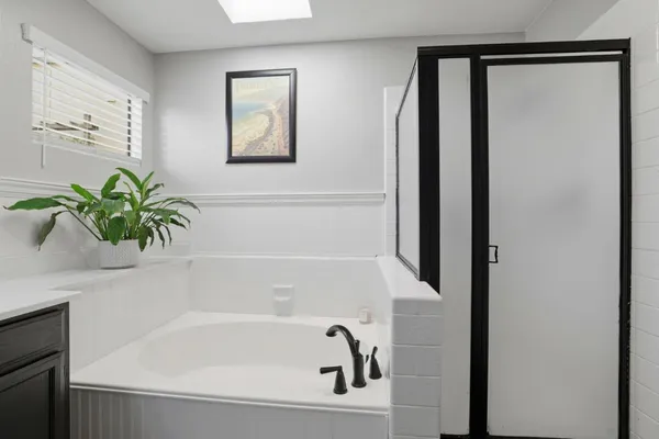 a bedroom with a bed and a painting