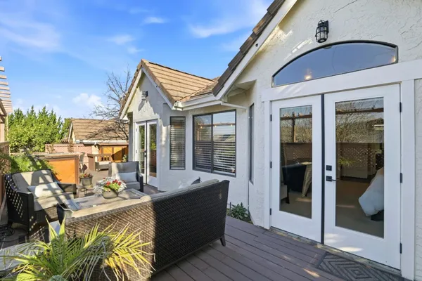 a view of a patio with couches table and chairs and potted plants