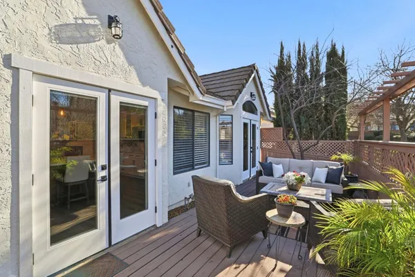 a view of a porch with furniture and garden