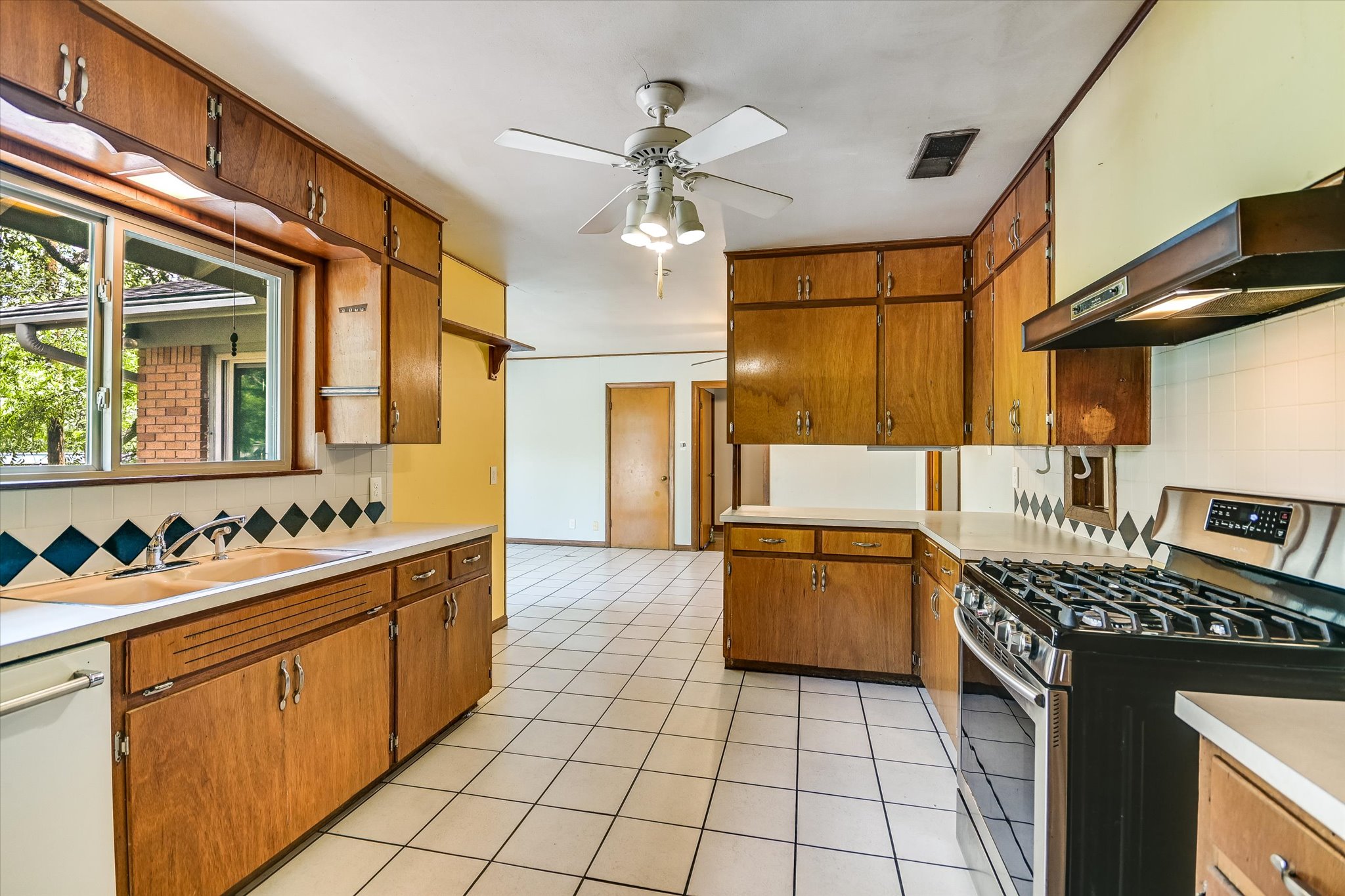 502 Sunset Circle Austin, TX 78704 - Photo 10 of 27 Tile floors, wood cabinetry, gas range
