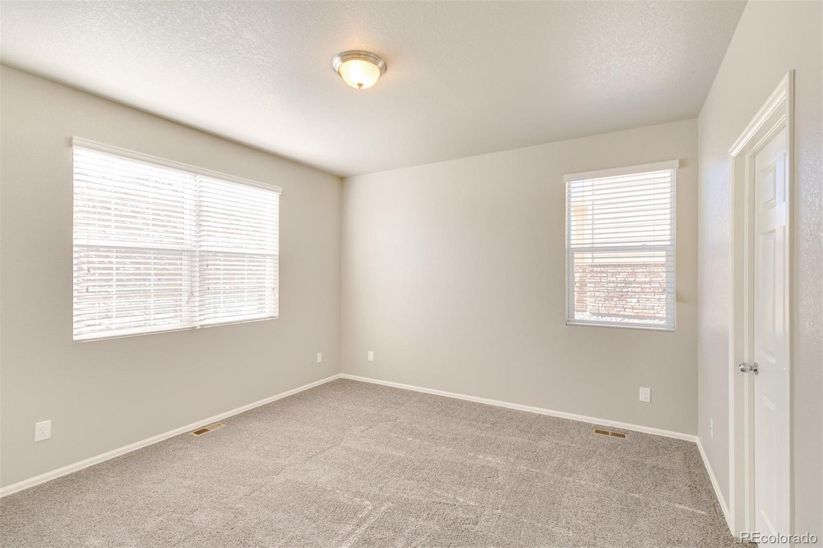 925 Camberly Drive Windsor, CO 80550 - Photo 17 of 29 an empty room with a window