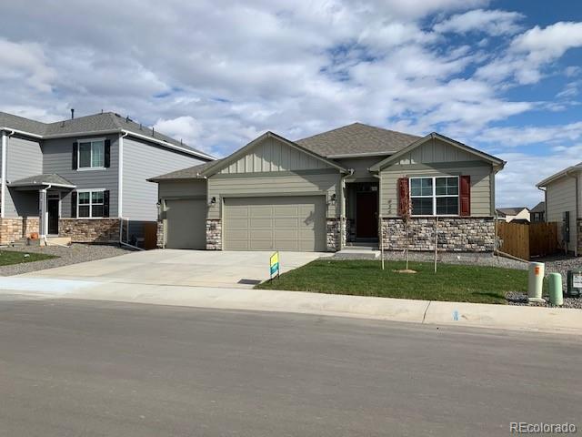 925 Camberly Drive Windsor, CO 80550 - Photo 2 of 29 a front view of a house with a yard and garage