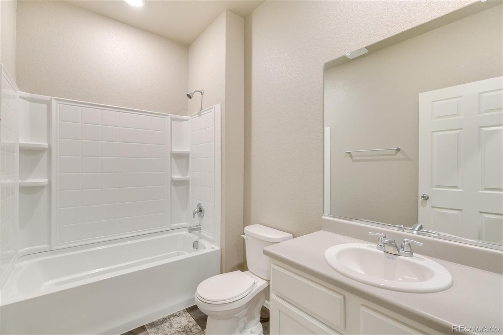925 Camberly Drive Windsor, CO 80550 - Photo 24 of 29 a bathroom with a sink toilet tub and shower