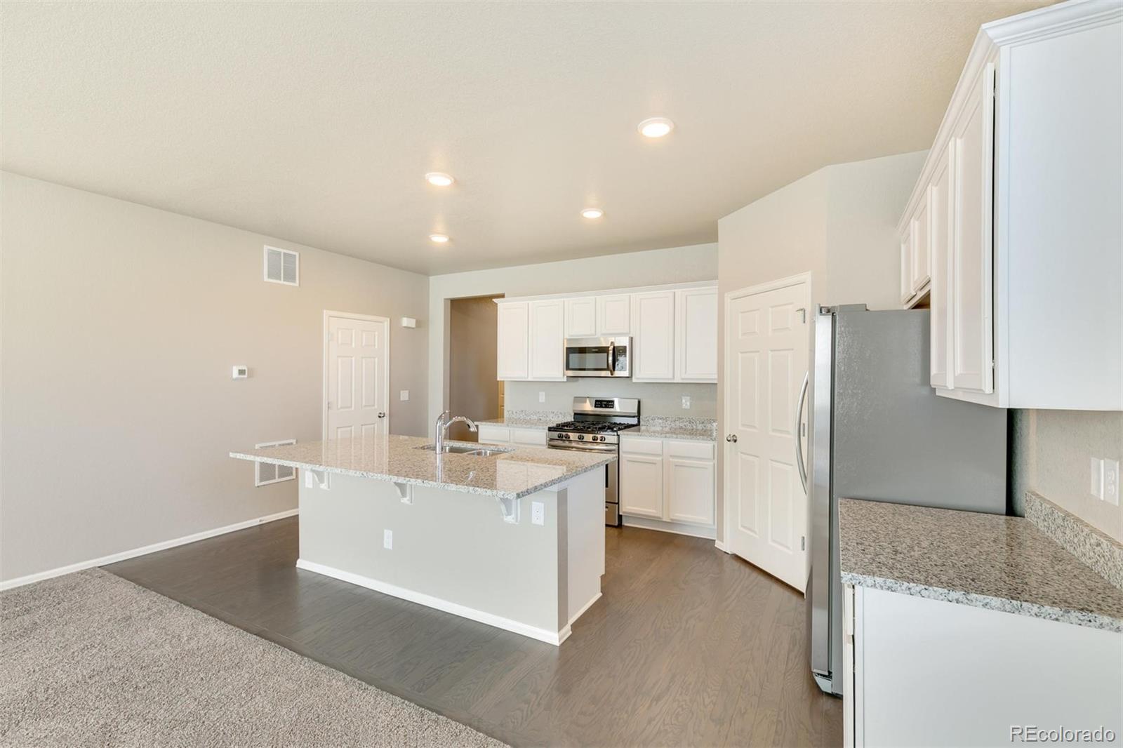 925 Camberly Drive Windsor, CO 80550 - Photo 10 of 29 a kitchen with refrigerator and cabinets