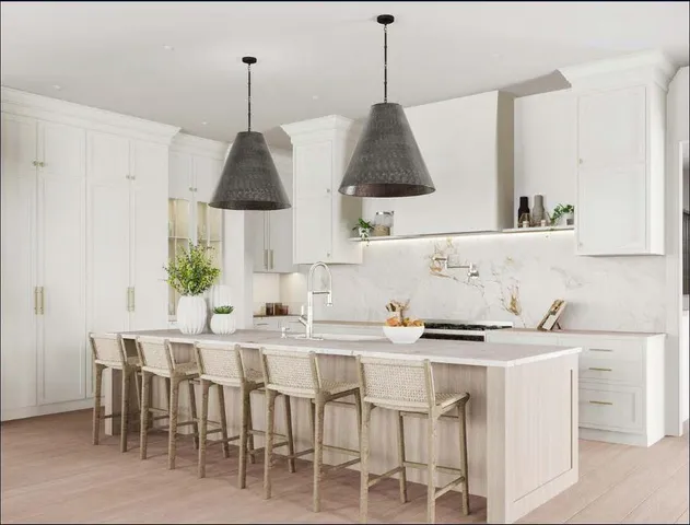 a kitchen with stainless steel appliances a sink stove and white cabinets