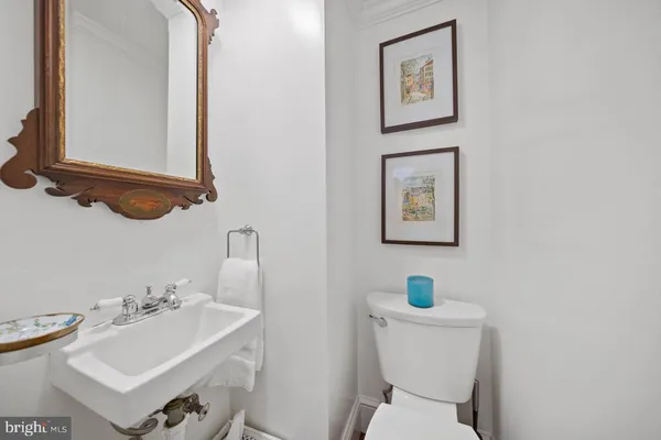 a bathroom with a toilet a sink and a mirror