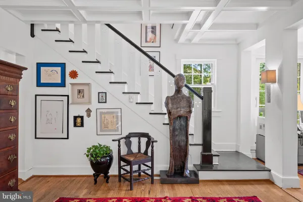 a view of entryway and hall with wooden floor
