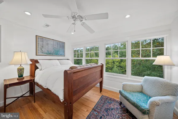a bedroom with a bed a couch and a window