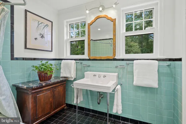 a bathroom with a bathtub a sink a toilet and mirror