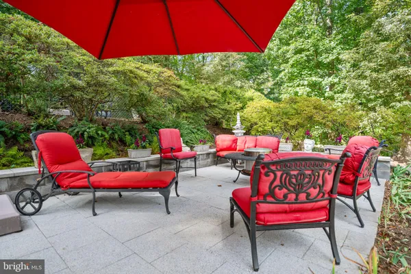 a view of a chairs and table in patio with a fire pit