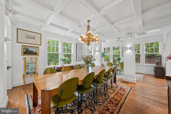 a view of a dining room with furniture wooden floor and chandelier