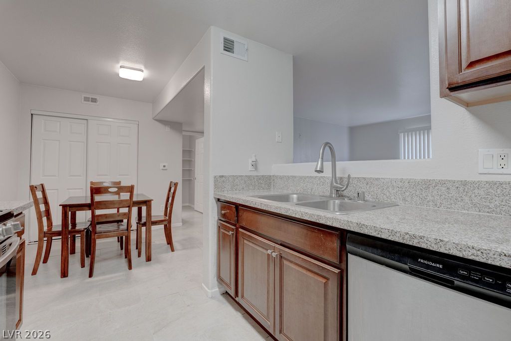 7885 West Flamingo Road, Unit 1016 Las Vegas, NV 89147 - Photo 13 of 24 Granite counters and stainless appliances define this modern, well-appointed kitchen.