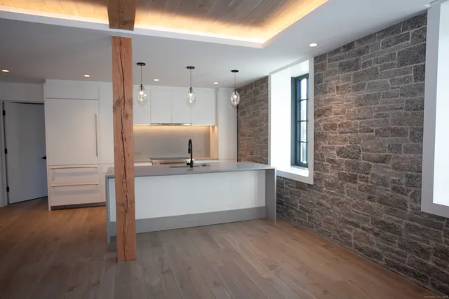 a kitchen with granite countertop a stove and a sink